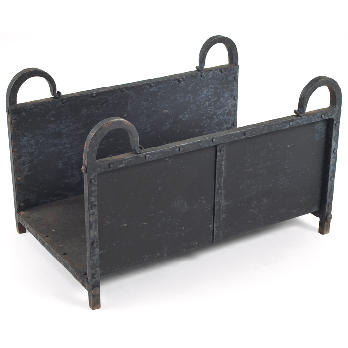 Appraisal: Arts and Crafts log holder in wrought ironwith curved handles