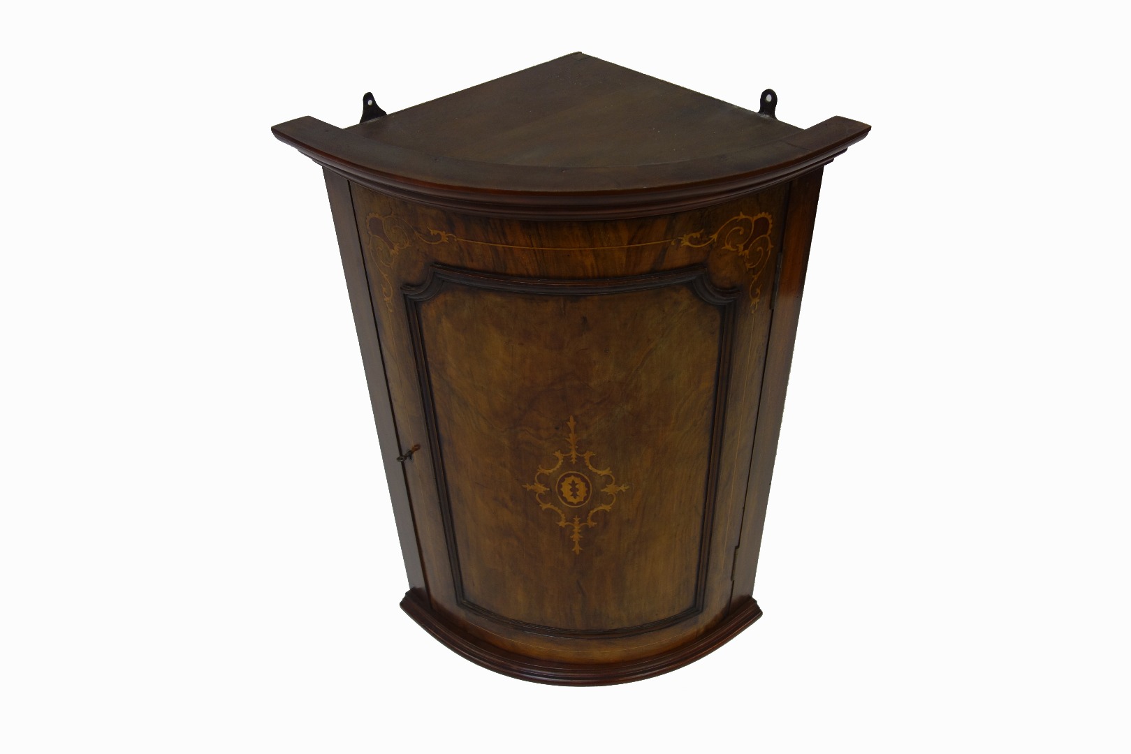 Appraisal: A walnut bowfronted hanging corner cabinet enclosed by a Victorian