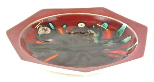 Appraisal: A Poole pottery hexagonal plate on a red ground cm