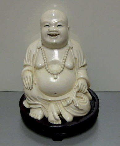 Appraisal: CHINESE IVORY LAUGHING BUDDHA Carved seated figure with long ear-lobs