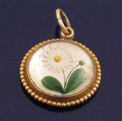 Appraisal: A gold pendant mounted with a reverse carved crystal depicting