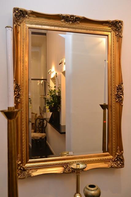 Appraisal: BEVEL EDGED WALL MIRROR WITH AN ORNATE FOLIATE CARVED GILT