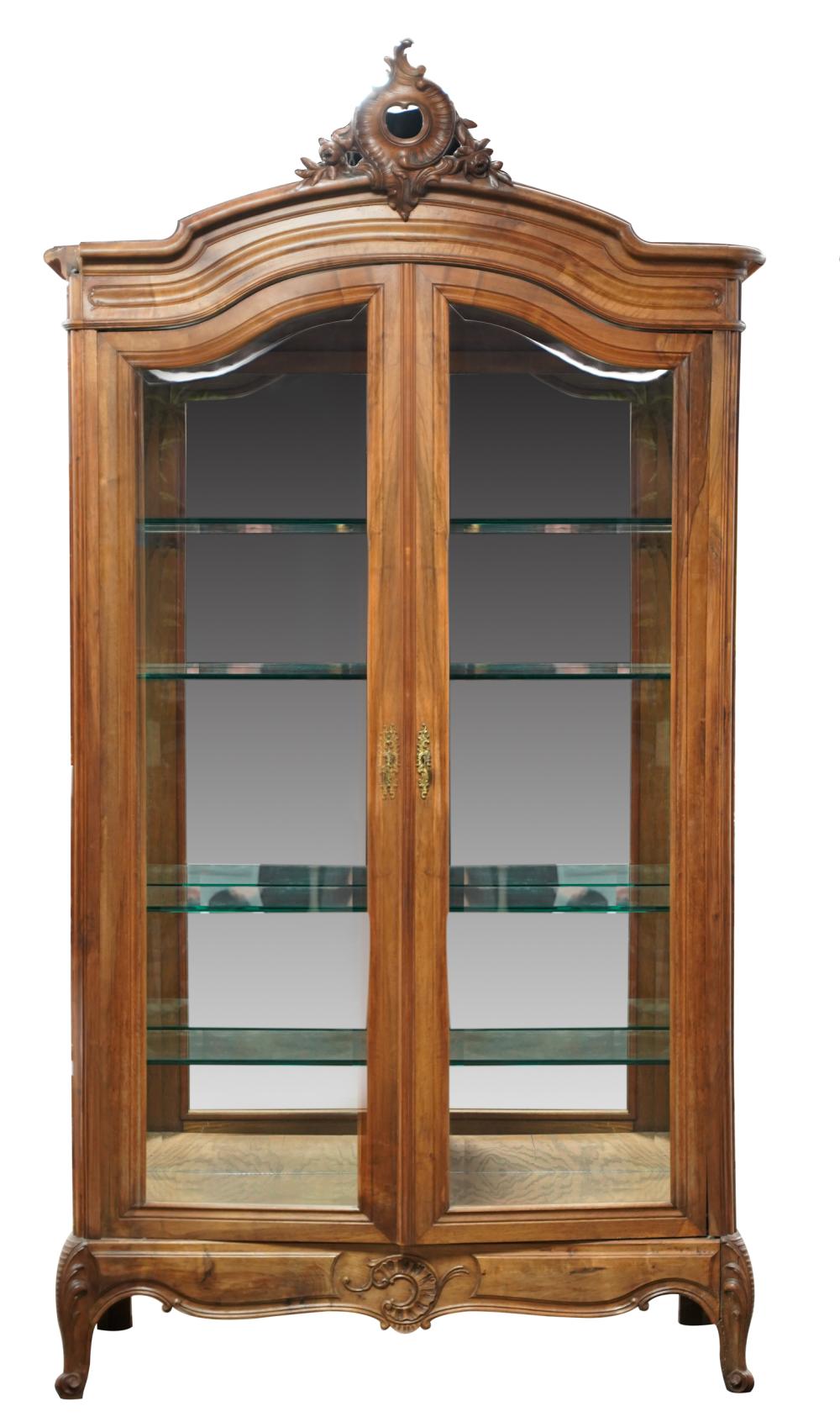 Appraisal: FRENCH PROVINCIAL-STYLE CARVED WALNUT VITRINEthe hinged doors and side panels