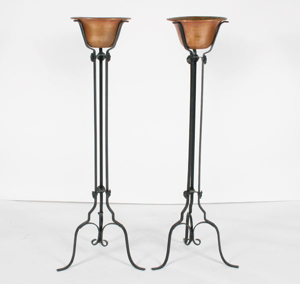 Appraisal: Wrought iron three-legged stands with attached rosettes and foliate decoration