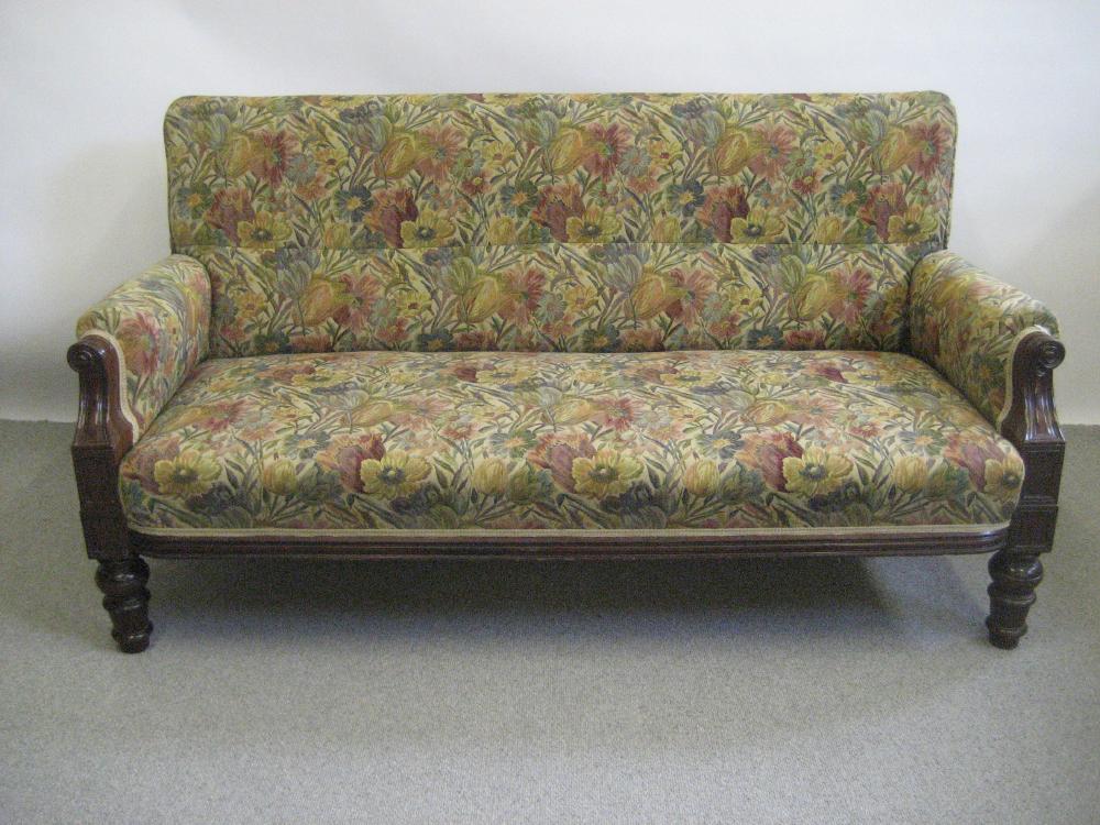 Appraisal: A VICTORIAN MAHOGANY FRAMED SETTEE upholstered in floral linen the