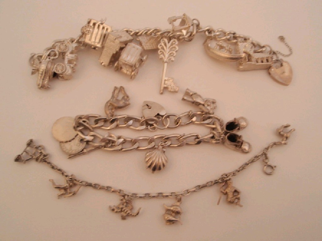 Appraisal: Three silver charm bracelets total weight g approx