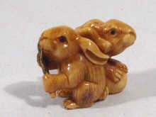 Appraisal: A Japanese ivory netsuke carving of two rabbits