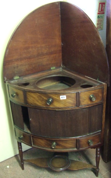 Appraisal: An early th century mahogany corner washstand the hinged splash