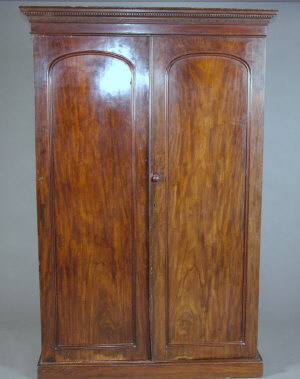 Appraisal: A Victorian mahogany double wardrobe the cornice above two arch