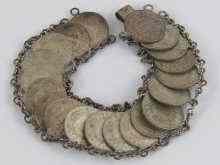 Appraisal: A white metal tests silver coin bracelet comprising twenty fourpenny