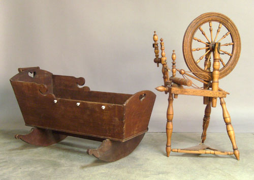 Appraisal: Spinning wheel together with a walnut cradle