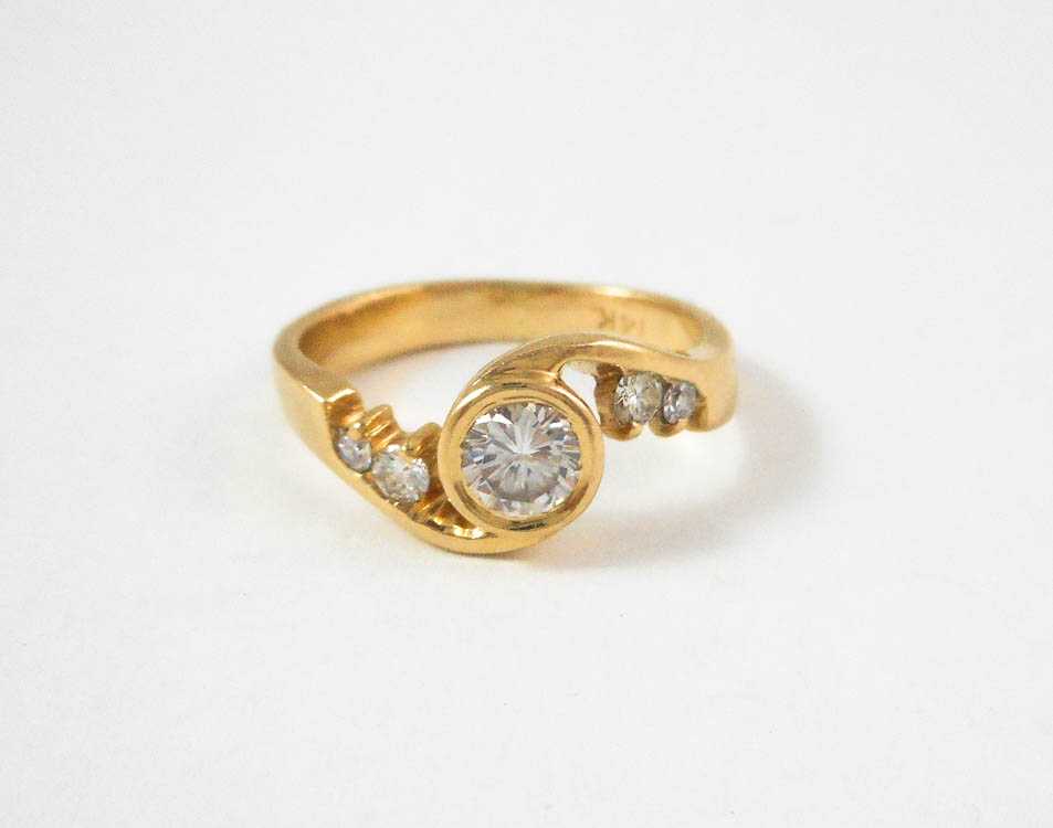 Appraisal: DIAMOND AND FOURTEEN KARAT GOLD RING with two round-cut diamonds