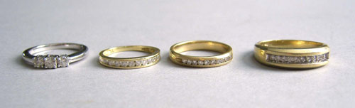 Appraisal: Four K gold and diamond wedding bands