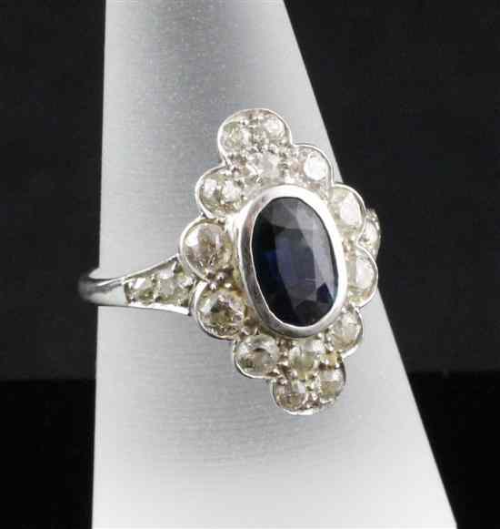 Appraisal: An ct white gold sapphire and diamond marquise shaped cluster