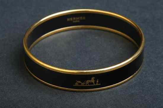 Appraisal: HERM S BLACK ENAMELLED AND GOLD PLATED BANGLE BRACELET Signed