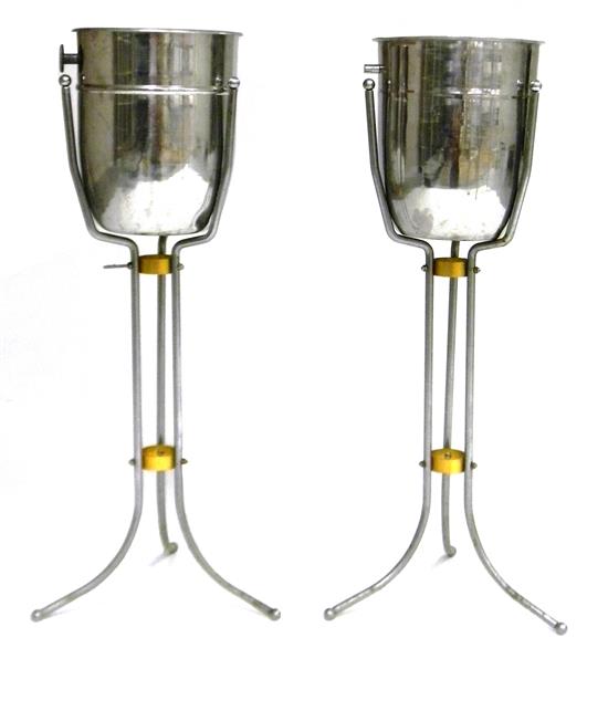 Appraisal: Two similar stainless steel champagne buckets on tripod metal stands