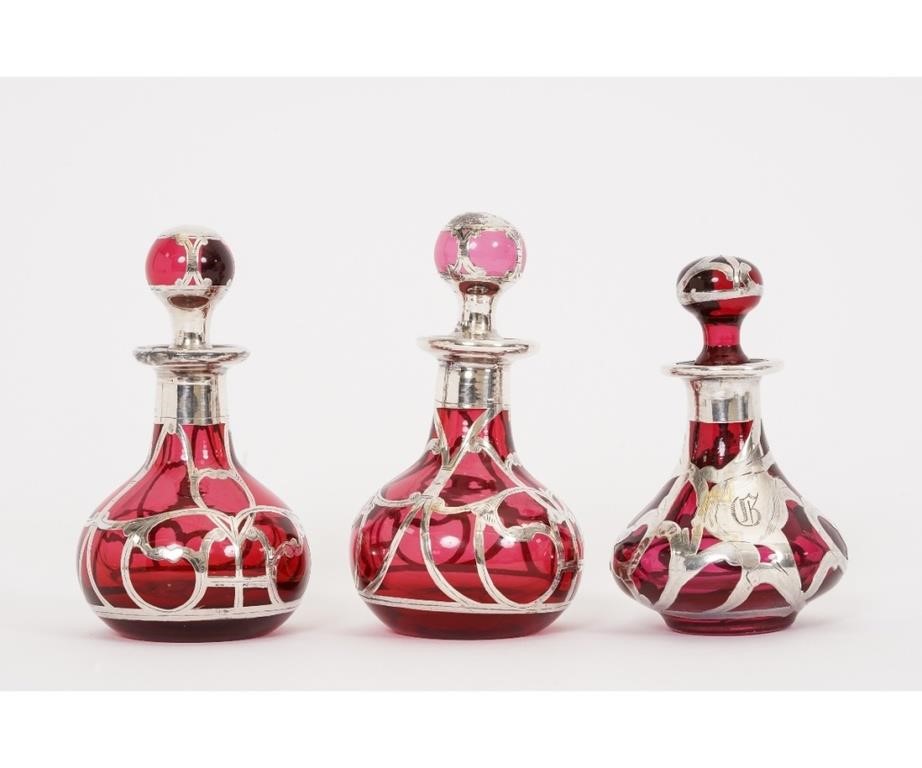 Appraisal: Three silver overlay red glass perfume bottles circa one with