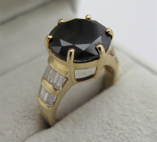 Appraisal: BLACK DIAMOND AND KARAT GOLD RING WITH APPRAISAL centering a