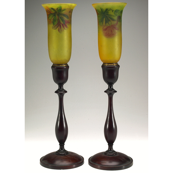 Appraisal: Pairpoint torcheres pair attribution wooden candlestick base supporting a reverse