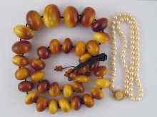 Appraisal: An amber necklace made from large graduated beads the largest