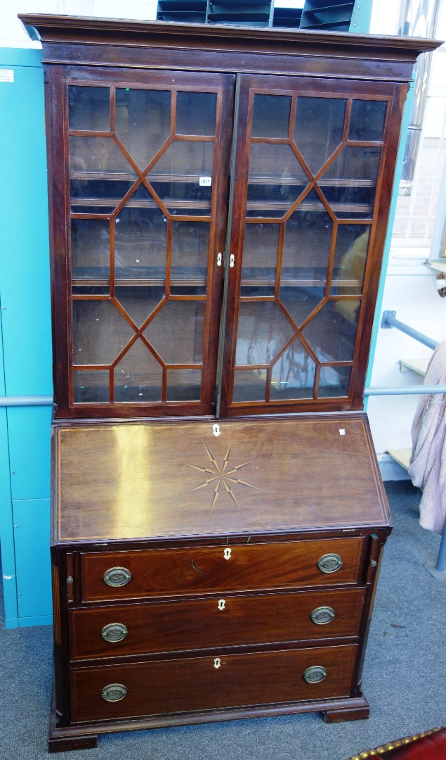 Appraisal: A George III and later mahogany bureau bookcase with canted