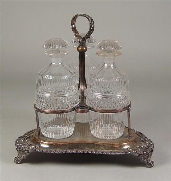 Appraisal: Silverplate Castor Set Early th Century Three cut glass decanters