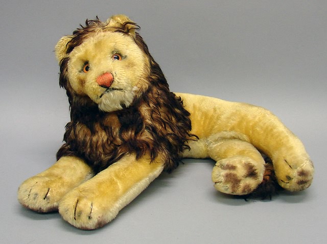 Appraisal: L Unmarked gold mohair reclining lion Brown tipped mane Small