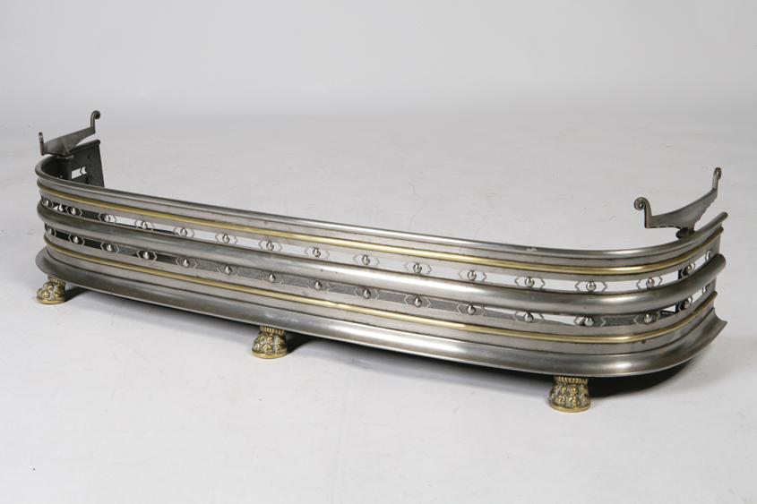 Appraisal: A REGENCY POLISHED STEEL AND BRASS FENDER of bowed form