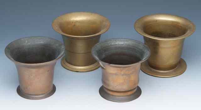 Appraisal: A GROUP OF FOUR ANTIQUE BRASS MORTARS the largest diameter