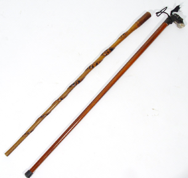 Appraisal: Two wooden walking canes one carved with a dog's head