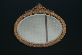 Appraisal: An oval guilded bevelled mirror