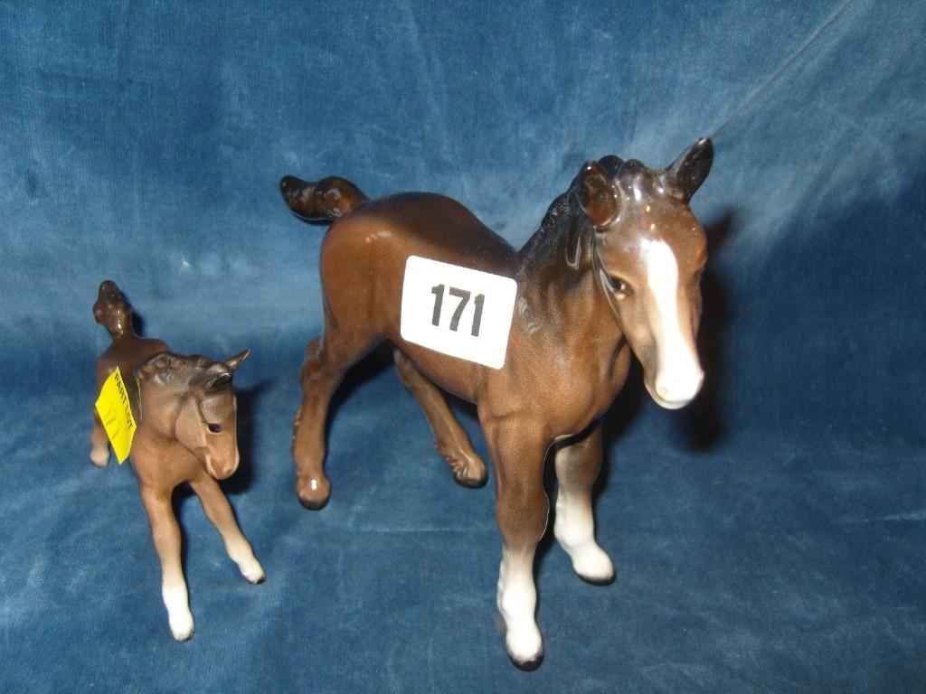 Appraisal: A large Beswick brown Shire foal together with a smaller