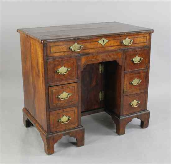 Appraisal: A George II banded walnut and parquetry kneehole desk with