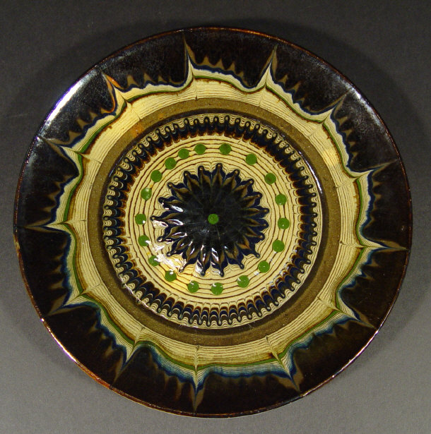 Appraisal: Keramis Art Pottery plate with floral slip decoration under an