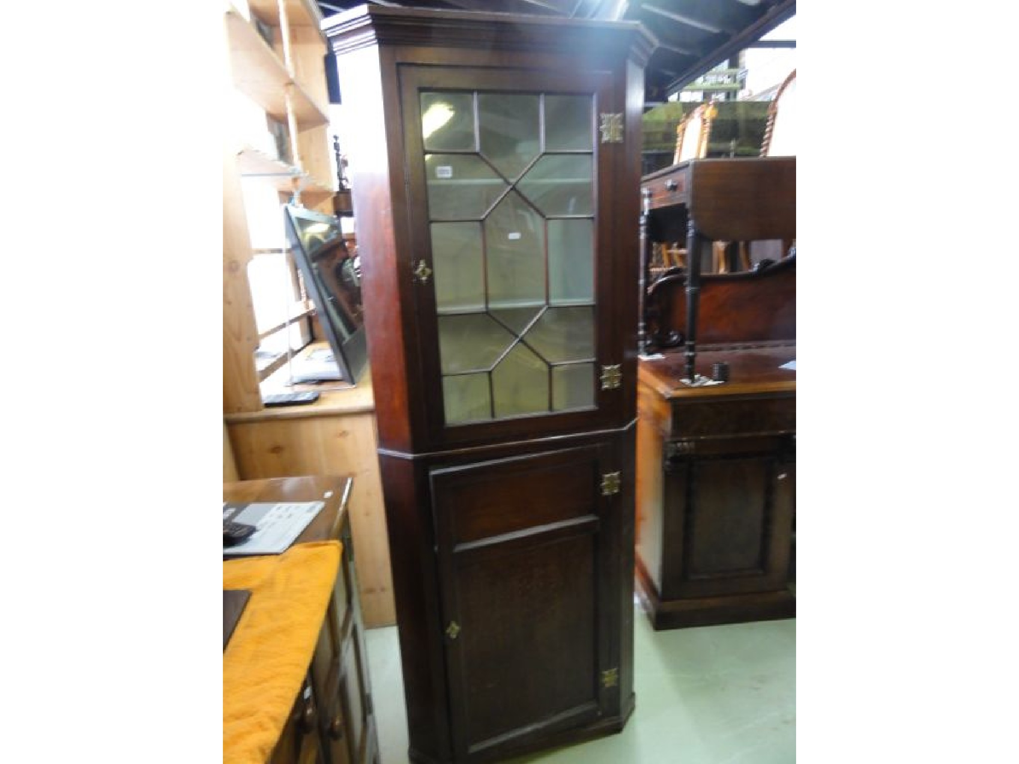 Appraisal: A th century mahogany floor standing corner cabinet enclosed by