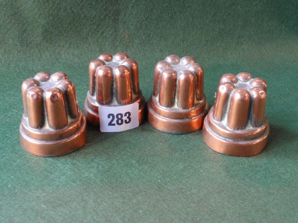 Appraisal: A set of four miniature copper jelly moulds