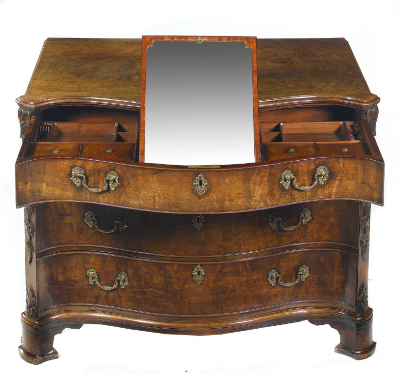 Appraisal: A GEORGE III MAHOGANY SERPENTINE DRESSING CHEST fitted four graduated