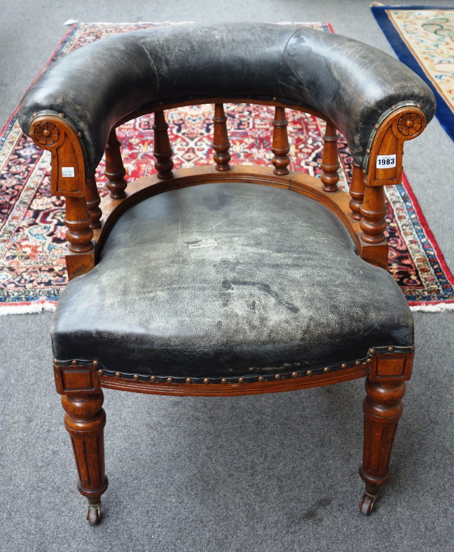 Appraisal: A Victorian oak and leather upholstered tub back office chair