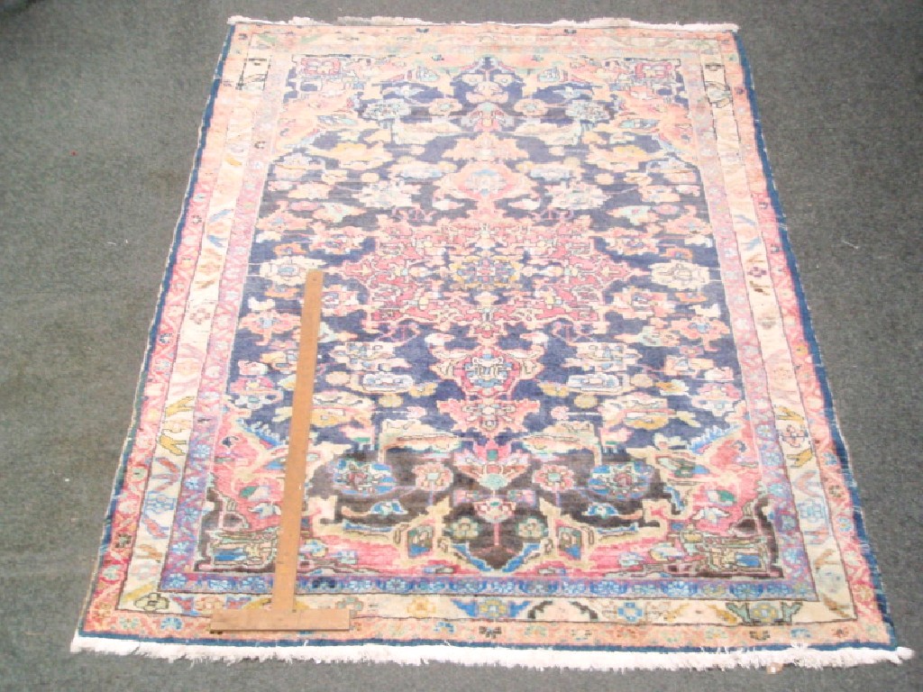 Appraisal: A Persian blue ground floral rug with multi borders cm