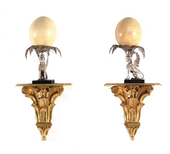 Appraisal: Pair Egyptian Revival ostrich egg and silverplate decorations on brackets