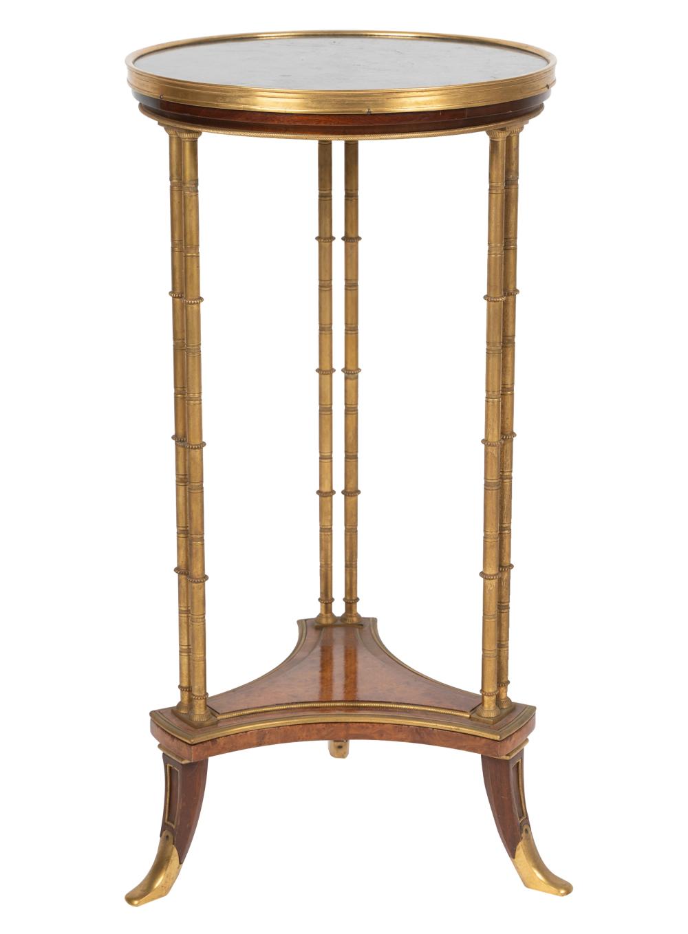 Appraisal: NEOCLASSIC STYLE GILT-METAL GUERIDON th century the round top inset