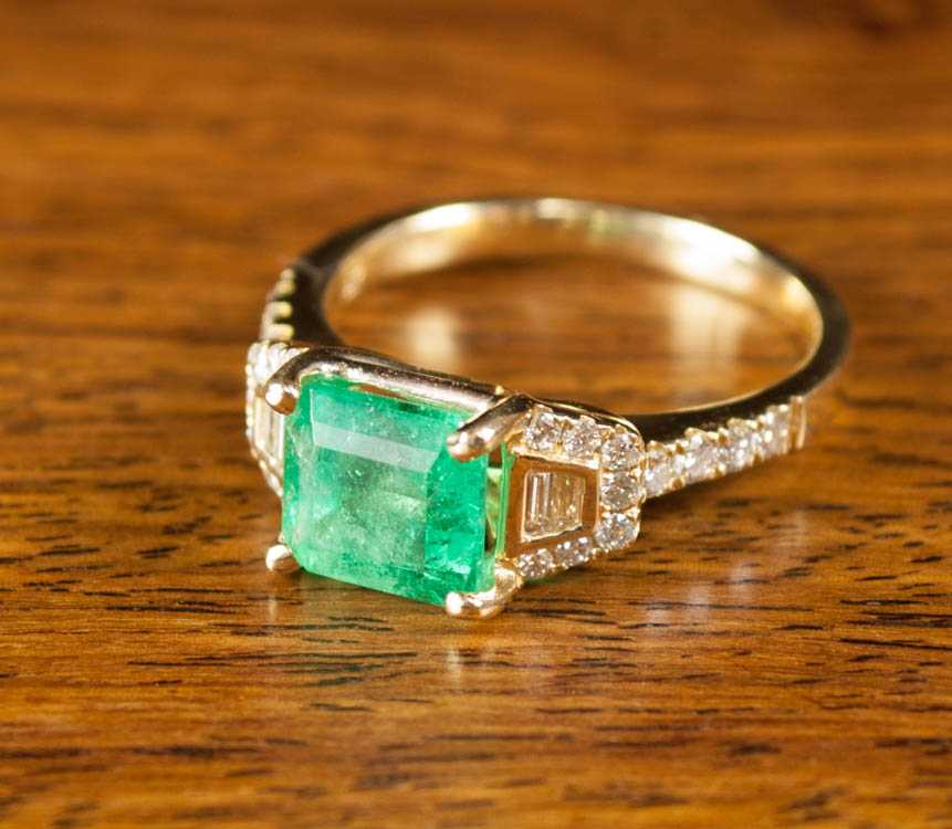 Appraisal: EMERALD DIAMOND AND EIGHTEEN KARAT GOLD RING with two baguette