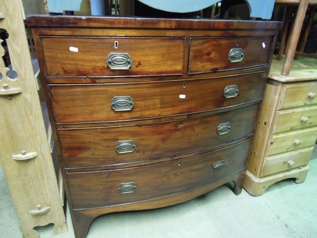 Appraisal: A Georgian mahogany bow fronted chest fitted with three long