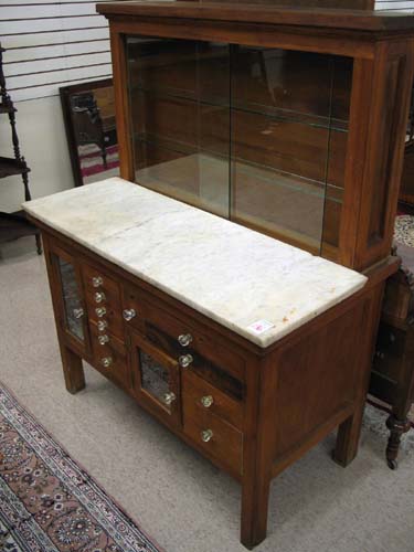 Appraisal: A MARBLE-TOPPED DENTIL CABINET American early th century having a