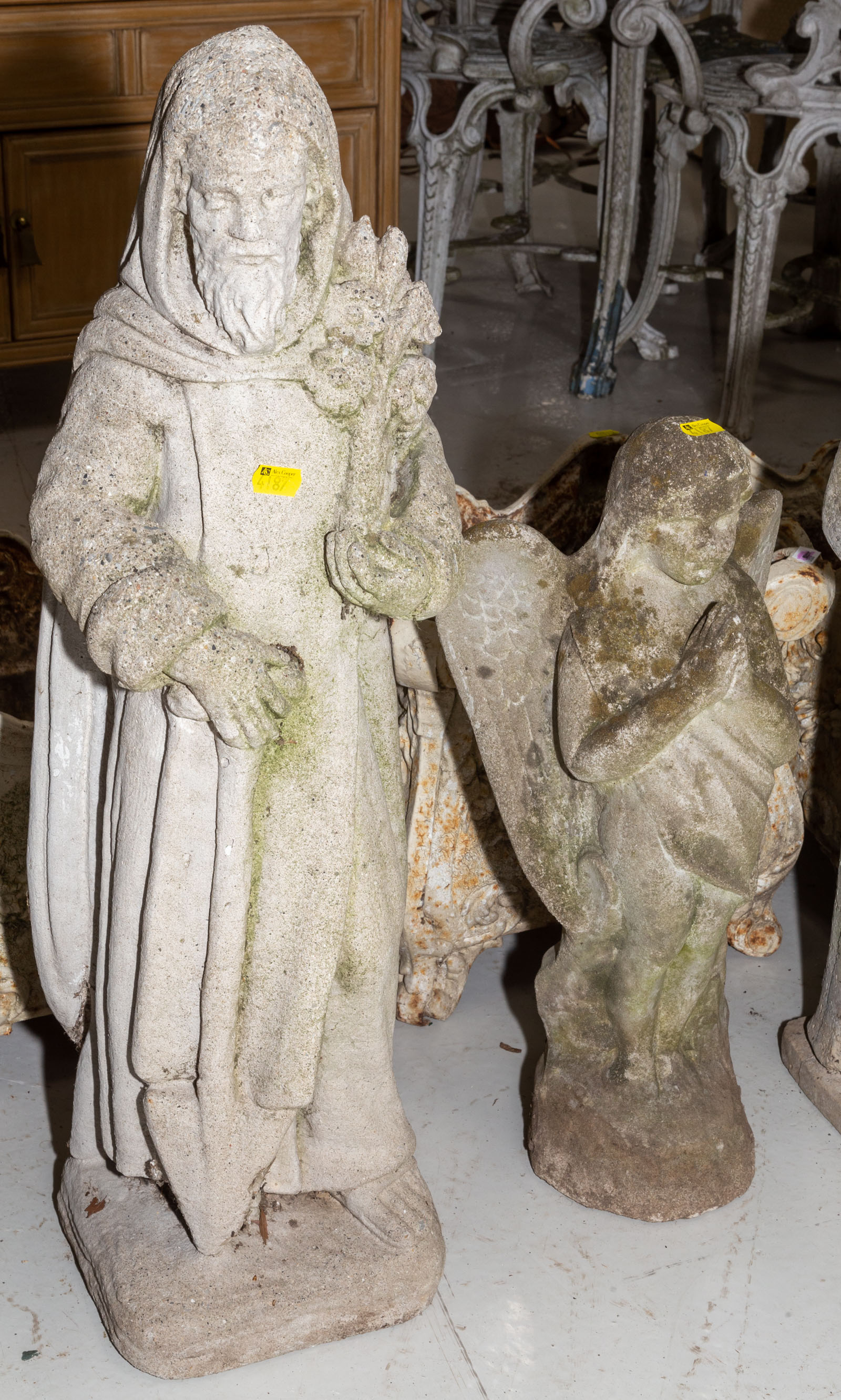 Appraisal: TWO CEMENT GARDEN FIGURES ST ISIDORE ANGEL th century comprising