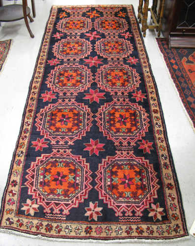 Appraisal: PERSIAN HALL CARPET overall geometric medallion and half-medallion design on