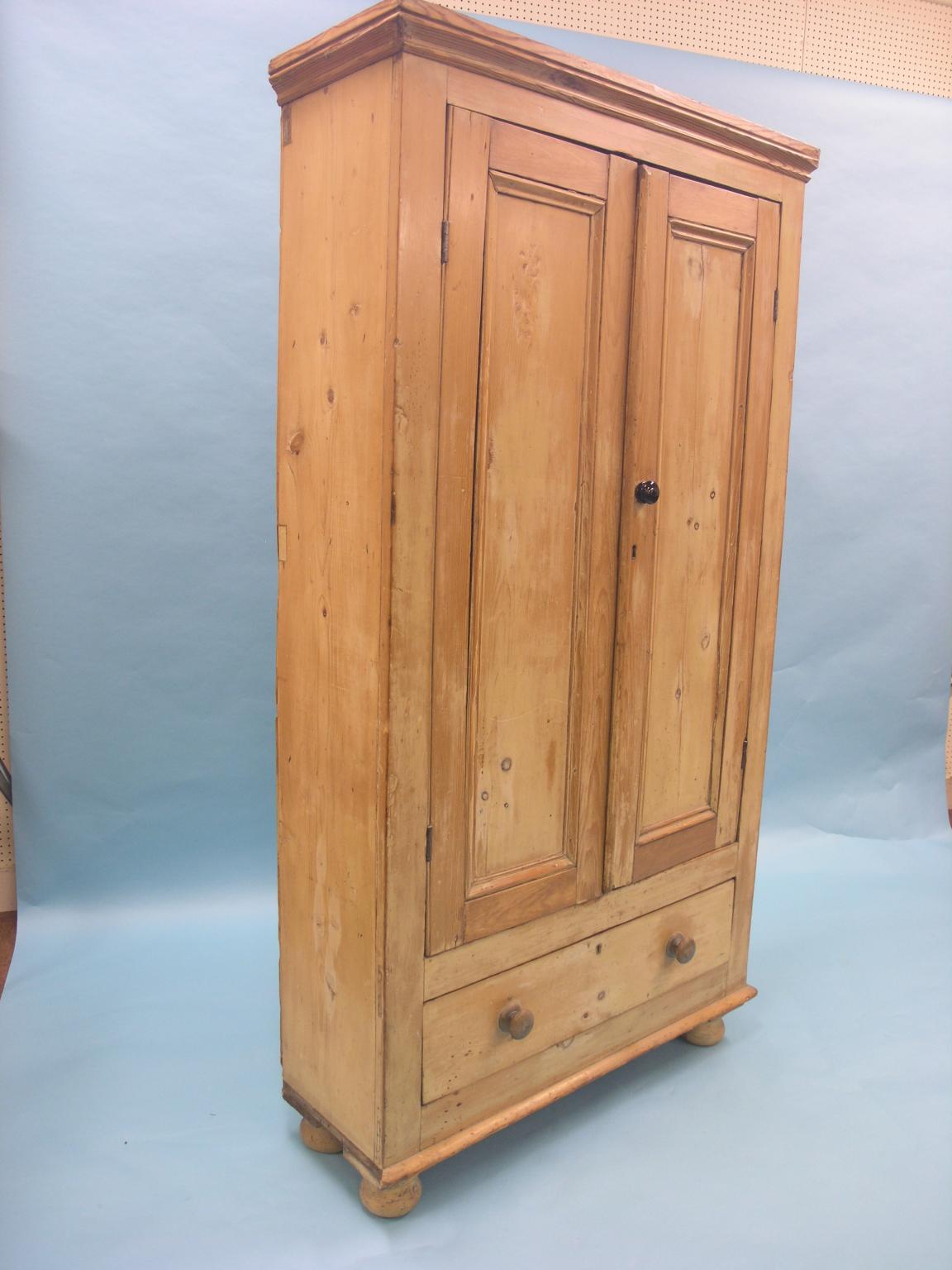 Appraisal: A Victorian stripped pine hall wardrobe pair of three-quarter length