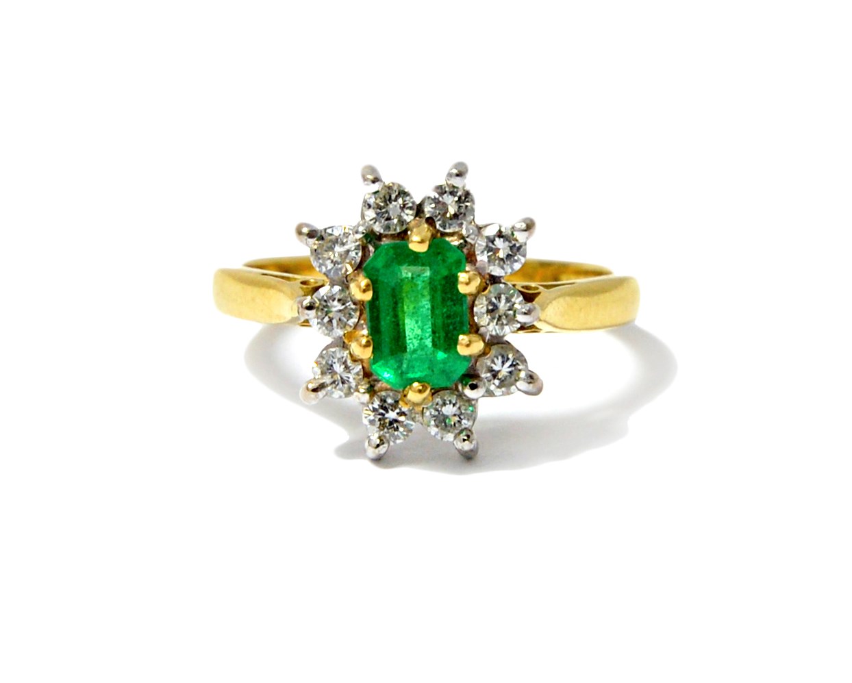 Appraisal: An ct gold emerald and diamond set cluster ring claw