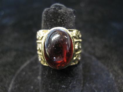 Appraisal: karat yellow gold cabochon garnet ringOval garnet cabochon bezel set