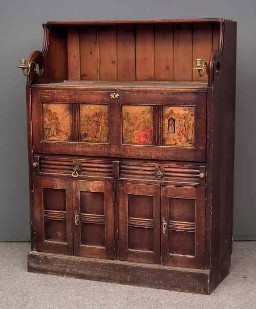 Appraisal: An unusual oak cabinet of Gothic design fitted two candle